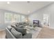 Bright living room with plantation shutters, a modern glass coffee table, and comfortable seating at 8017 Chilton Dr, Orlando, FL 32836