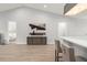Open-concept floorplan with a view of a bar area, a bedroom, and a decorative cabinet with an art piece above at 8017 Chilton Dr, Orlando, FL 32836
