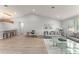 Spacious living room featuring high ceilings, wood floors, a modern desk, and comfortable seating area at 8017 Chilton Dr, Orlando, FL 32836