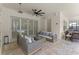 Covered patio area with comfortable seating, a ceiling fan, and a view of the pool area at 8017 Chilton Dr, Orlando, FL 32836