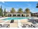 Stunning community pool lined with palm trees and lounge chairs for a resort-like living experience at 8017 Chilton Dr, Orlando, FL 32836