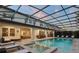 Breathtaking pool and patio with an outdoor kitchen, dining area, and a spa for resort-style living at 8017 Chilton Dr, Orlando, FL 32836