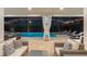 Covered patio with comfortable seating overlooking the screened-in pool and spa at 8017 Chilton Dr, Orlando, FL 32836