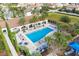 A community pool surrounded by palm trees and lounge chairs at 8017 Chilton Dr, Orlando, FL 32836
