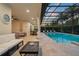 Inviting covered patio with an outdoor kitchen, dining area, and a sparkling pool with a spa at 8017 Chilton Dr, Orlando, FL 32836
