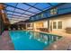 The refreshing pool boasts a screened enclosure, perfect for relaxation and outdoor living at 8017 Chilton Dr, Orlando, FL 32836