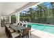 Outdoor dining area with an outdoor pool and a spa at 8017 Chilton Dr, Orlando, FL 32836
