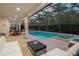 Relaxing pool and spa area with an outdoor dining set, lounge chairs, and a tranquil backyard setting at 8017 Chilton Dr, Orlando, FL 32836