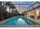 Fantastic pool with integrated spa, with backyard views, and palm trees, and fully screened-in enclosure at 8017 Chilton Dr, Orlando, FL 32836