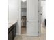 Walk-in closet next to a bathroom that has built-in storage, racks, and shelves at 8017 Chilton Dr, Orlando, FL 32836