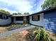 Beautifully landscaped front yard with a charming walkway leading to the entrance at 905 W 11Th Ave, Mount Dora, FL 32757