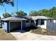 Charming single-story home with a well-maintained lawn, attached garage, and a welcoming front porch at 905 W 11Th Ave, Mount Dora, FL 32757