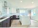 Modern kitchen featuring stainless steel appliances, marble backsplash, and a kitchen island with seating at 905 W 11Th Ave, Mount Dora, FL 32757