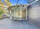 Enclosed porch boasts a beautiful patio area with brick floors and walls of screened windows for natural lighting at 905 W 11Th Ave, Mount Dora, FL 32757