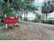 Sylvan Park entrance with lush landscaping, leading to scenic views and lake access at 905 W 11Th Ave, Mount Dora, FL 32757
