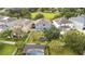 Back aerial view of a home showcasing a fenced backyard, trampoline, screened-in pool, and mature trees at 12651 Winding Woods Ln, Orlando, FL 32832