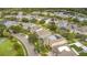 Community aerial view with well-maintained homes, landscaping, and a scenic pond with mature trees at 12651 Winding Woods Ln, Orlando, FL 32832