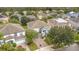 Stunning aerial view of a two-story home with lush landscaping, brick driveway, and a well-maintained lawn at 12651 Winding Woods Ln, Orlando, FL 32832