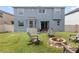 Large backyard with a fire pit, patio set, and lush grass, perfect for outdoor entertaining at 12651 Winding Woods Ln, Orlando, FL 32832
