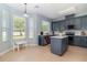 Eat-in kitchen with an island, stainless appliances, and abundant natural light at 12651 Winding Woods Ln, Orlando, FL 32832