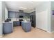 Kitchen featuring an island, stainless appliances, white countertops, and painted blue-gray cabinets at 12651 Winding Woods Ln, Orlando, FL 32832