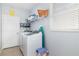 Functional laundry room equipped with a modern washing machine, storage shelves, and a folding area at 12651 Winding Woods Ln, Orlando, FL 32832