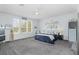 Spacious main bedroom featuring a ceiling fan, carpeted floor, and ample natural light from multiple windows at 12651 Winding Woods Ln, Orlando, FL 32832