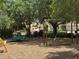 Community playground featuring swings, a merry-go-round, and a safe, wood chip surface for children at 12651 Winding Woods Ln, Orlando, FL 32832