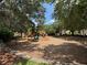 Spacious community playground featuring a variety of slides, swings, and climbing structures surrounded by mature trees at 12651 Winding Woods Ln, Orlando, FL 32832