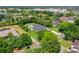 Aerial view of a home, showcasing its swimming pool, surrounded by lush trees and landscaping at 13710 Lake Cawood Dr, Windermere, FL 34786