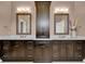 Bathroom featuring double vanities, dark wood cabinets, and luxurious countertops at 13710 Lake Cawood Dr, Windermere, FL 34786