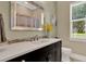 Bathroom showcasing a dark wood vanity, modern fixtures, and a large mirror at 13710 Lake Cawood Dr, Windermere, FL 34786