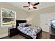 Comfortable bedroom features a ceiling fan, natural light, and ample closet space at 13710 Lake Cawood Dr, Windermere, FL 34786