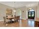 Elegant dining room with hardwood floors, chandelier, and a decorative mirror wall at 13710 Lake Cawood Dr, Windermere, FL 34786