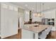 Modern kitchen featuring a large island, stainless steel appliances, and sleek white cabinetry at 13710 Lake Cawood Dr, Windermere, FL 34786