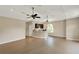 Open-concept living room with sleek flooring, recessed lighting, and a wet bar with seating at 13710 Lake Cawood Dr, Windermere, FL 34786