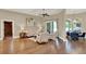 Bright living room with hardwood floors, cozy seating, and sliding glass doors to the lanai at 13710 Lake Cawood Dr, Windermere, FL 34786