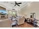 Expansive living room featuring tray ceilings, modern lighting and a stone fireplace at 13710 Lake Cawood Dr, Windermere, FL 34786