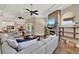 Large living room with stone fireplace, comfortable seating, and view to kitchen at 13710 Lake Cawood Dr, Windermere, FL 34786