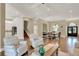 Open-concept living space with hardwood floors flowing into dining area and staircase at 13710 Lake Cawood Dr, Windermere, FL 34786