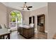 Home office features a large window, hardwood floors, a ceiling fan, and built-in bookshelves at 13710 Lake Cawood Dr, Windermere, FL 34786