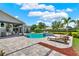 The backyard features a covered outdoor kitchen, swimming pool with hot tub, and sun loungers at 13710 Lake Cawood Dr, Windermere, FL 34786