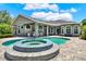 A beautiful swimming pool with an integrated hot tub is set in a large brick-paved backyard at 13710 Lake Cawood Dr, Windermere, FL 34786