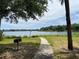 Path to the lake with barbecue grill in the backyard on a sunny day at 1420 Lake Shadow Cir # 9207, Maitland, FL 32751