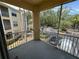 Screened balcony with views of the surrounding landscaping and parking lot at 1420 Lake Shadow Cir # 9207, Maitland, FL 32751