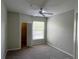 Neutral bedroom featuring carpet, ceiling fan, a large window, and a closet at 1420 Lake Shadow Cir # 9207, Maitland, FL 32751