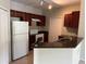 Eat-in kitchen with stainless steel appliances, tile floors, and dark wood cabinets at 1420 Lake Shadow Cir # 9207, Maitland, FL 32751