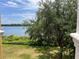 Picturesque lake view framed by lush greenery and trees; viewed from private balcony at 1420 Lake Shadow Cir # 9207, Maitland, FL 32751