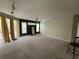 Bright living room featuring a ceiling fan, sliding glass doors to balcony, and neutral carpet at 1420 Lake Shadow Cir # 9207, Maitland, FL 32751