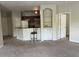 Open-concept living room features a bar, doorway to the kitchen, and neutral carpet at 1420 Lake Shadow Cir # 9207, Maitland, FL 32751